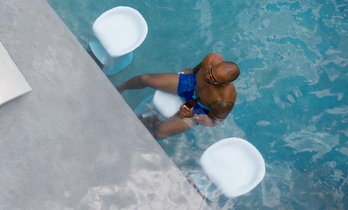 White Signature Bar Height in-pool barstools at a swim-up counter