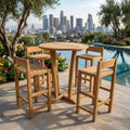 Round teak outdoor bar table with four slatted bar chairs beside a pool overlooking a city.