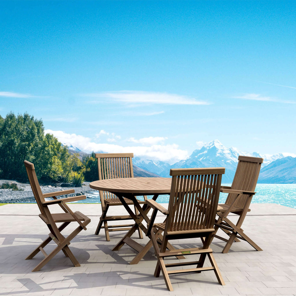 Bahama Classic five-piece teak dining set with round folding table and four armchairs in an outdoor mountain setting