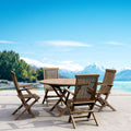 Bahama Classic five-piece teak dining set with round folding table and four armchairs in an outdoor mountain setting