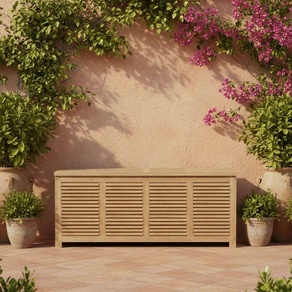 Amberly teak storage box with closed lid against a garden wall with flowering vines