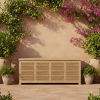 Amberly teak storage box with closed lid against a garden wall with flowering vines