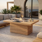 Teak fire pit dining table with place settings and a lit central burner on a sea-view terrace.