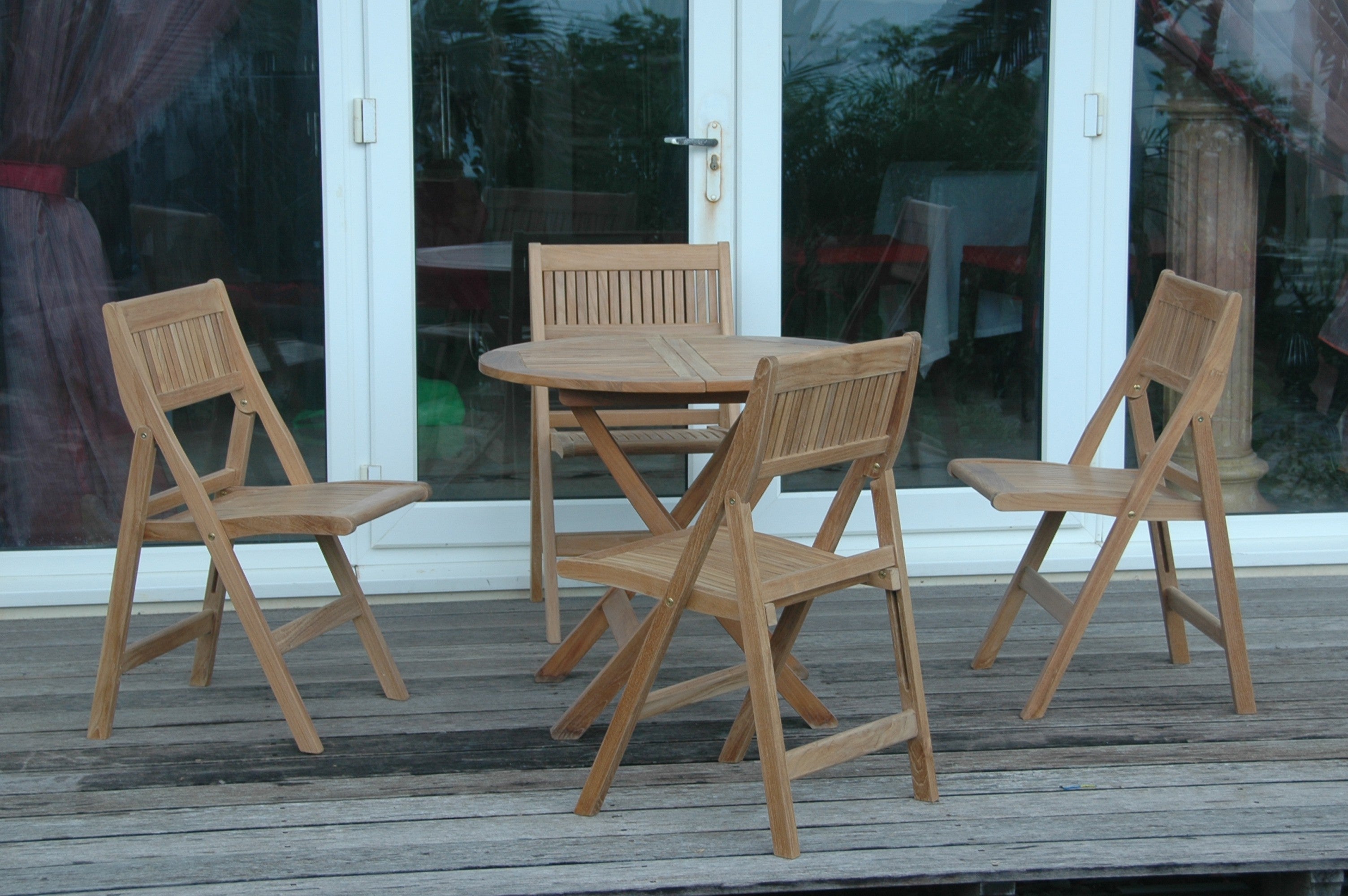 Windsor 5-Piece Bistro Set on a patio near glass doors