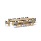 Angled view of the Coronado teak extension dining table with twelve cushioned armchairs.