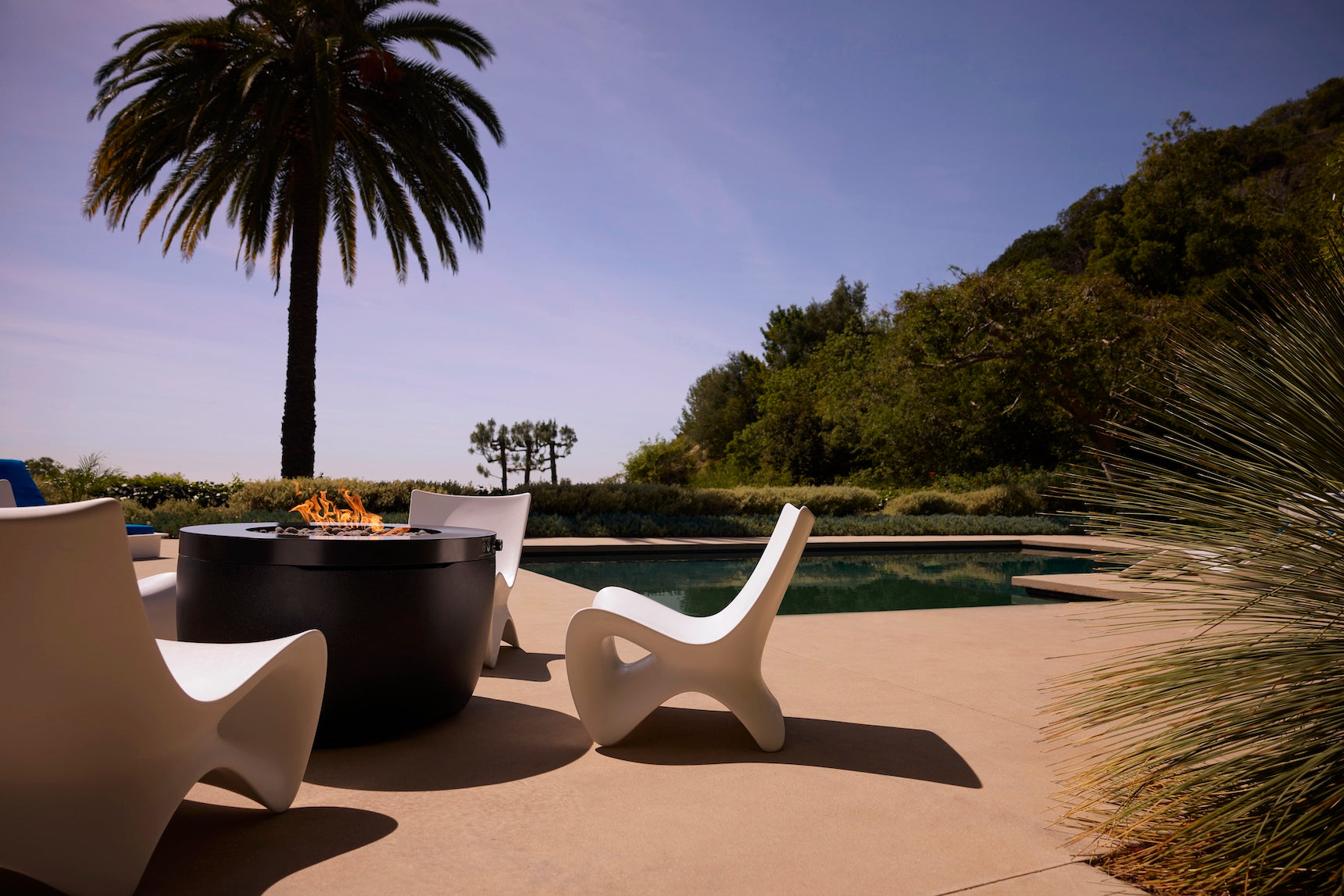 Ledge Lounger Autograph Chair lifestyle, White, poolside fire pit entertaining setup