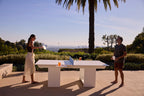 Outdoor table tennis and dining table on a landscaped terrace overlooking the city