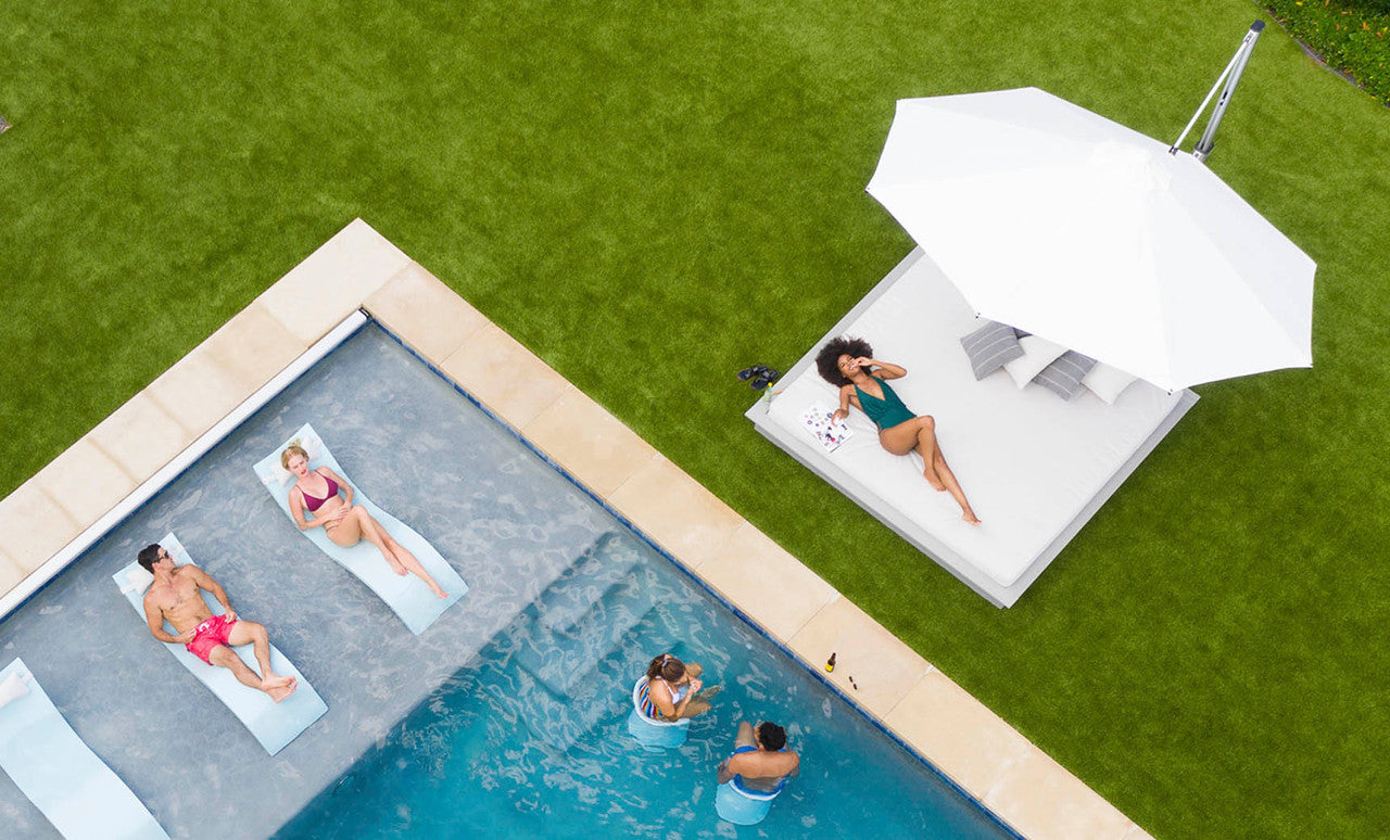 Ledge Lounger Ultra Cantilever Umbrella aerial lifestyle, poolside loungers under shade
