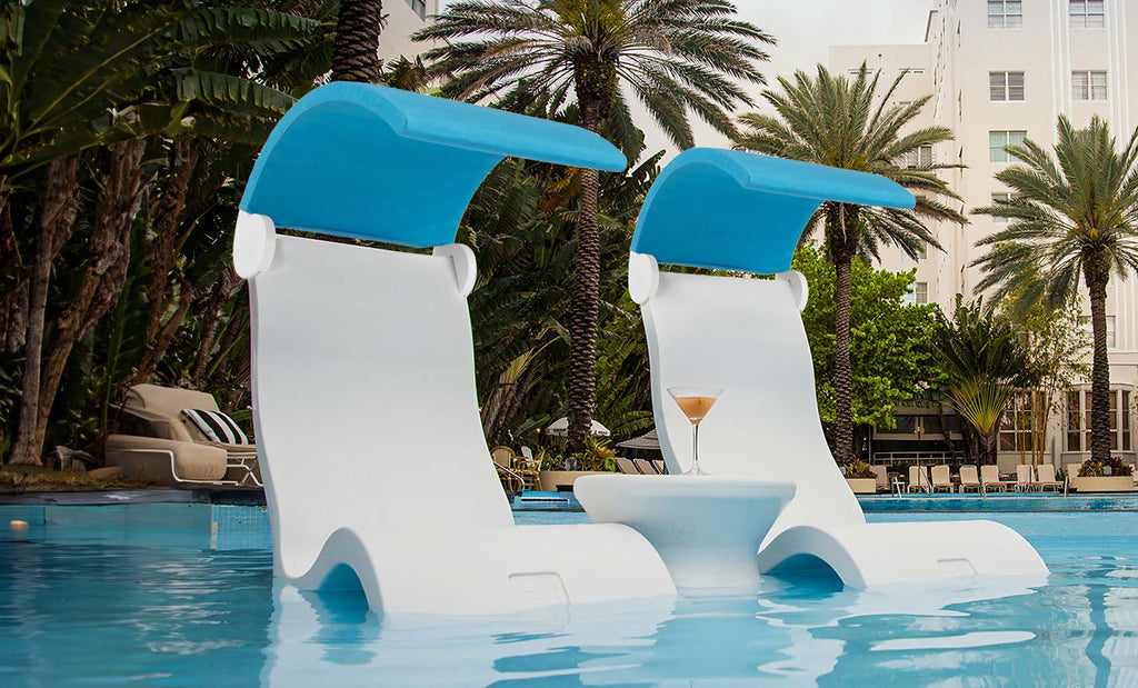 Two white Ledge Lounger Signature Chair Shades with blue canopies on an in-pool tanning ledge