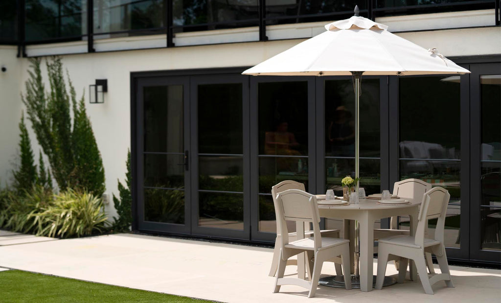 Ledge Lounger Mainstay Round Dining Table lifestyle, under umbrella poolside patio