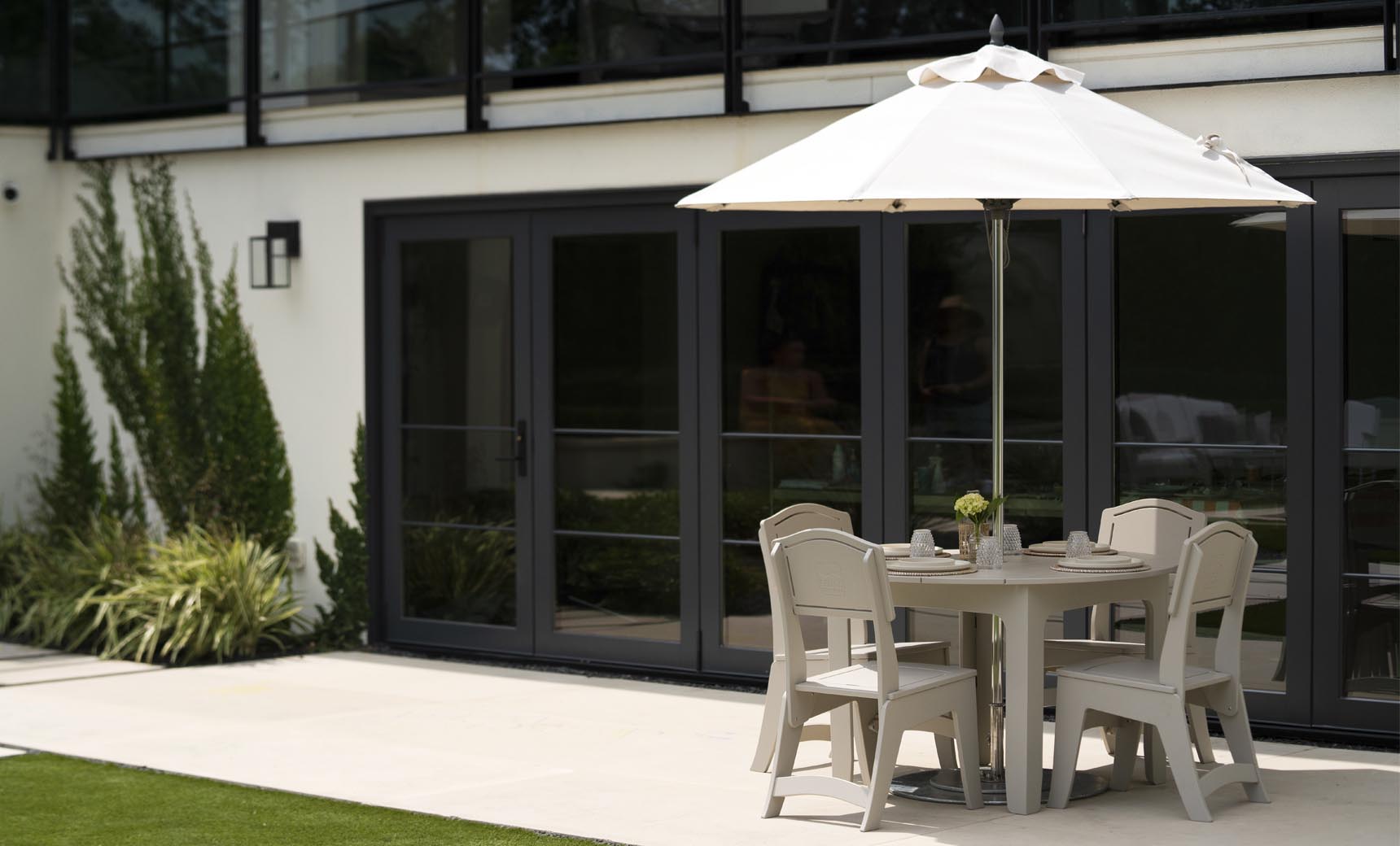 Ledge Lounger Mainstay Round Dining Table lifestyle, under umbrella poolside patio