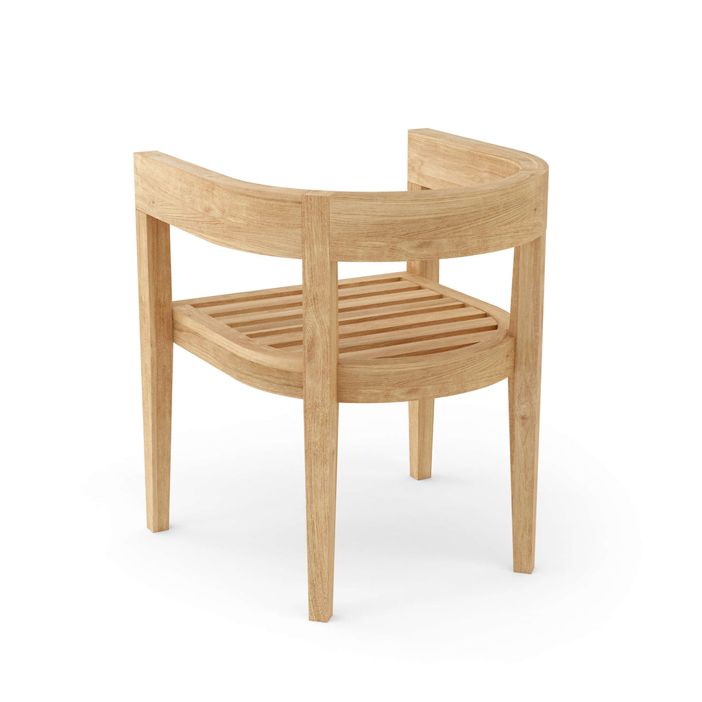 Angled view of a Coronado teak dining armchair without its seat and back cushions.