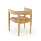 Angled view of a Coronado teak dining armchair without its seat and back cushions.