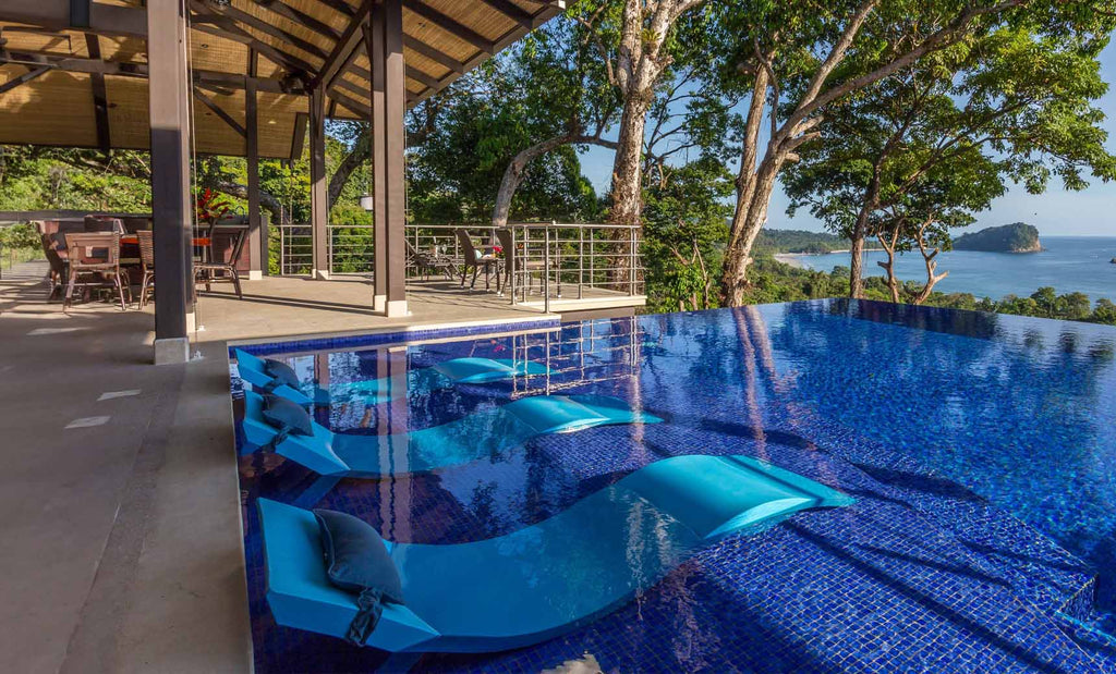 White Signature Chaise submerged on a tiled indoor pool ledge