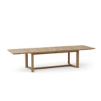 Angled view of the Coronado rectangular teak dining table with extension leaves in place.