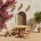 Andrew Butterfly five-piece teak dining set in a sunny courtyard