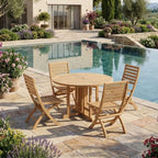 Andrew Butterfly round teak dining table and four folding chairs beside a villa pool