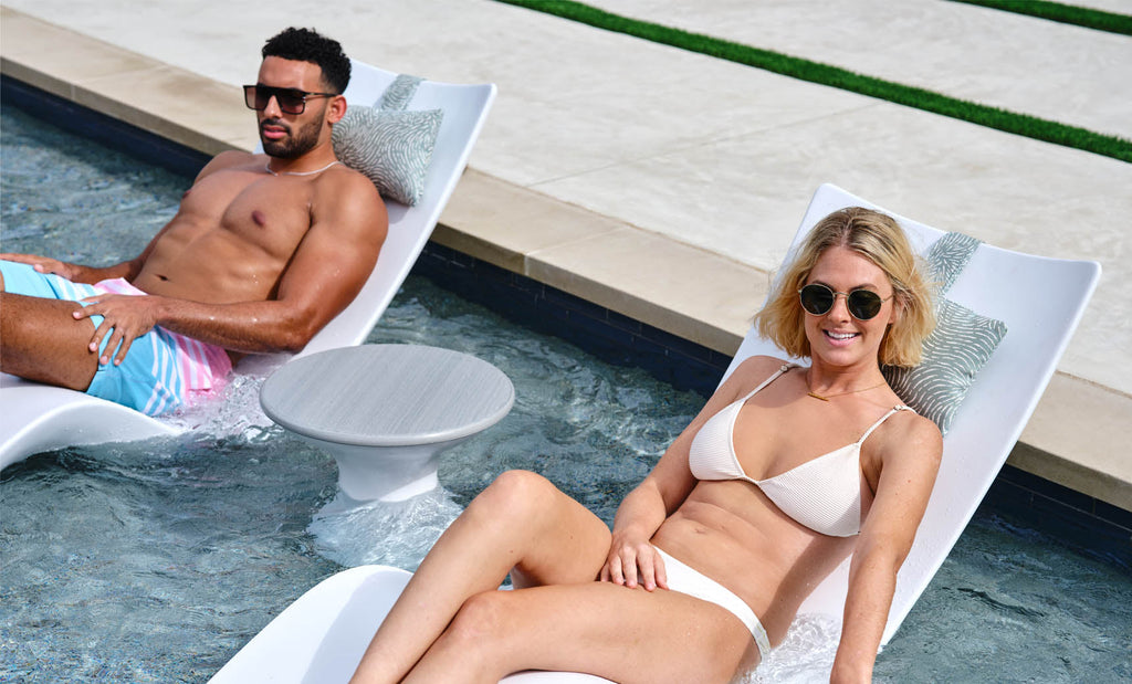 Autograph Standard Side Table between two chaises on a shallow pool ledge; seating sold separately