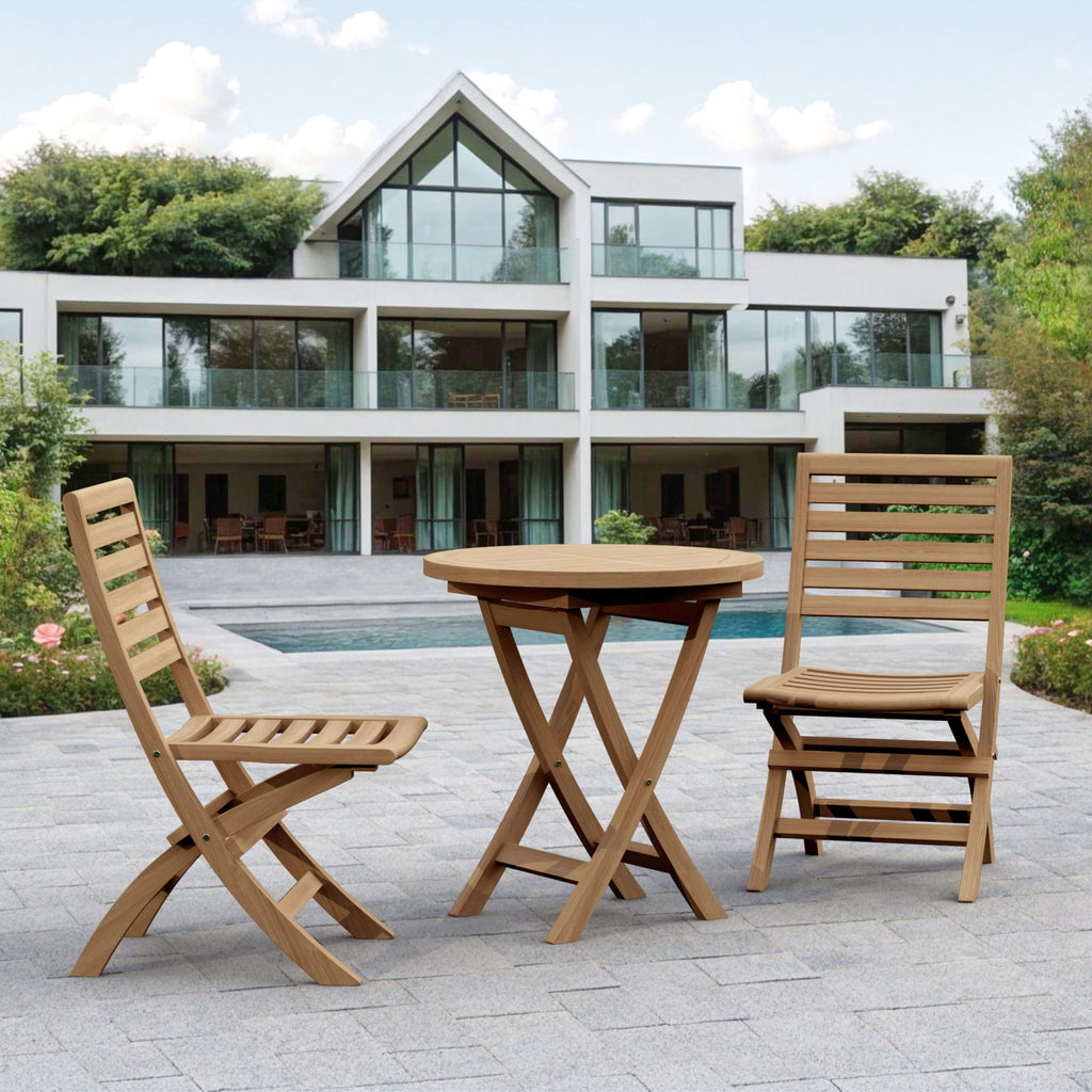 Bahama Andrew teak bistro table and two folding chairs on a modern pool terrace
