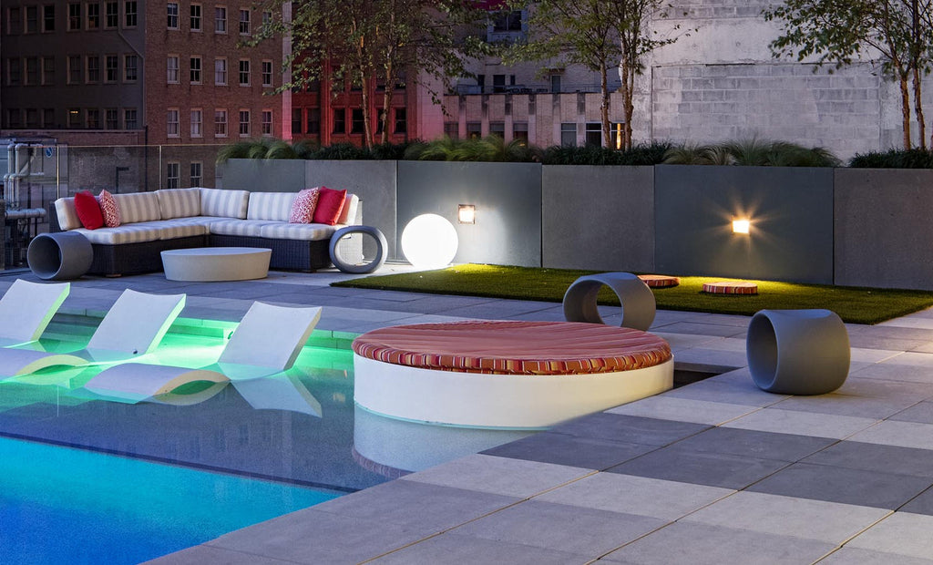 Signature Round Sunbed in a resort-style rooftop pool setting