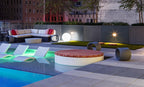 Signature Round Sunbed in a resort-style rooftop pool setting