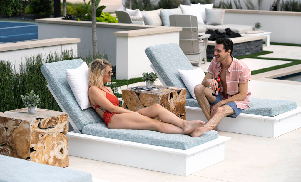 White Ledge Lounger Echo Chaise with White cushion beside a pool