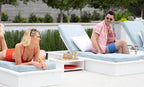 White Ledge Lounger Echo Side Table between two poolside lounge chairs