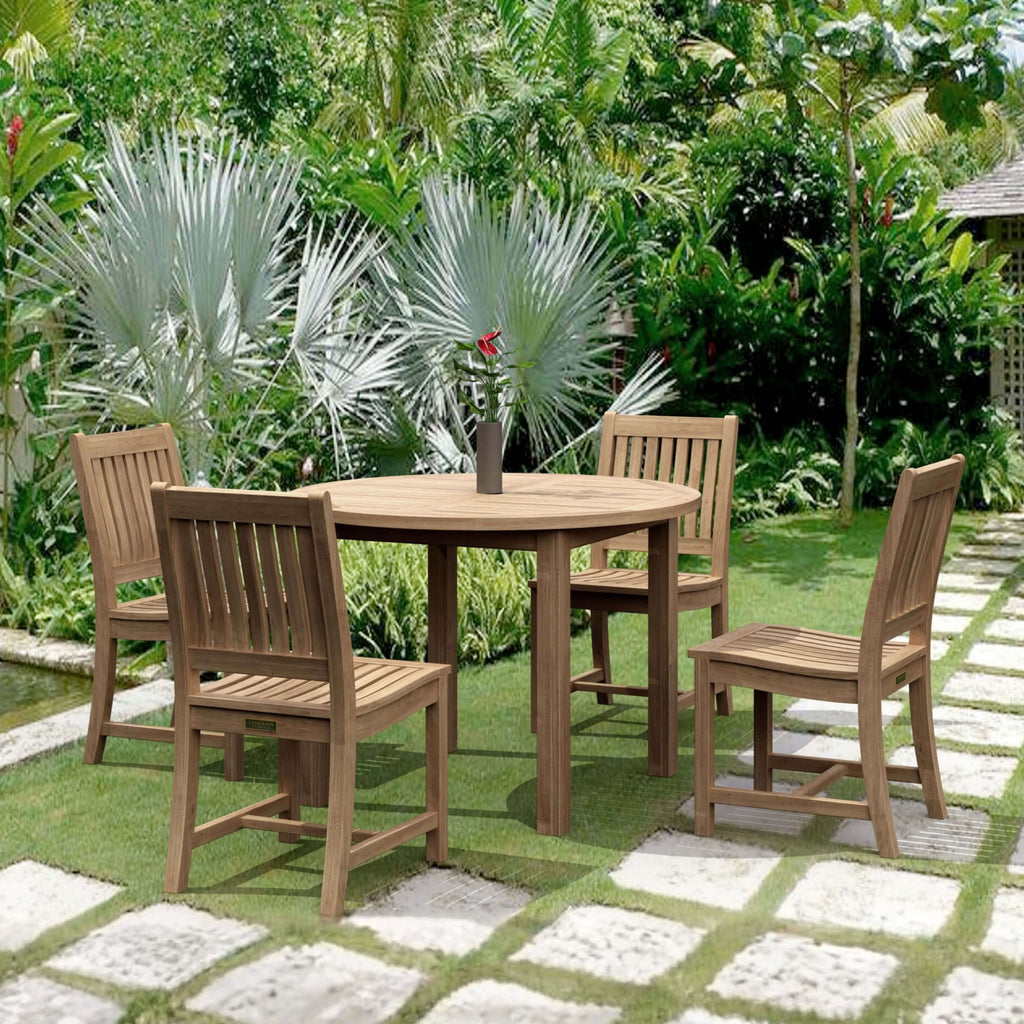 Sommerset five-piece round teak dining set with four Rialto chairs in a tropical garden