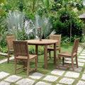 Sommerset five-piece round teak dining set with four Rialto chairs in a tropical garden