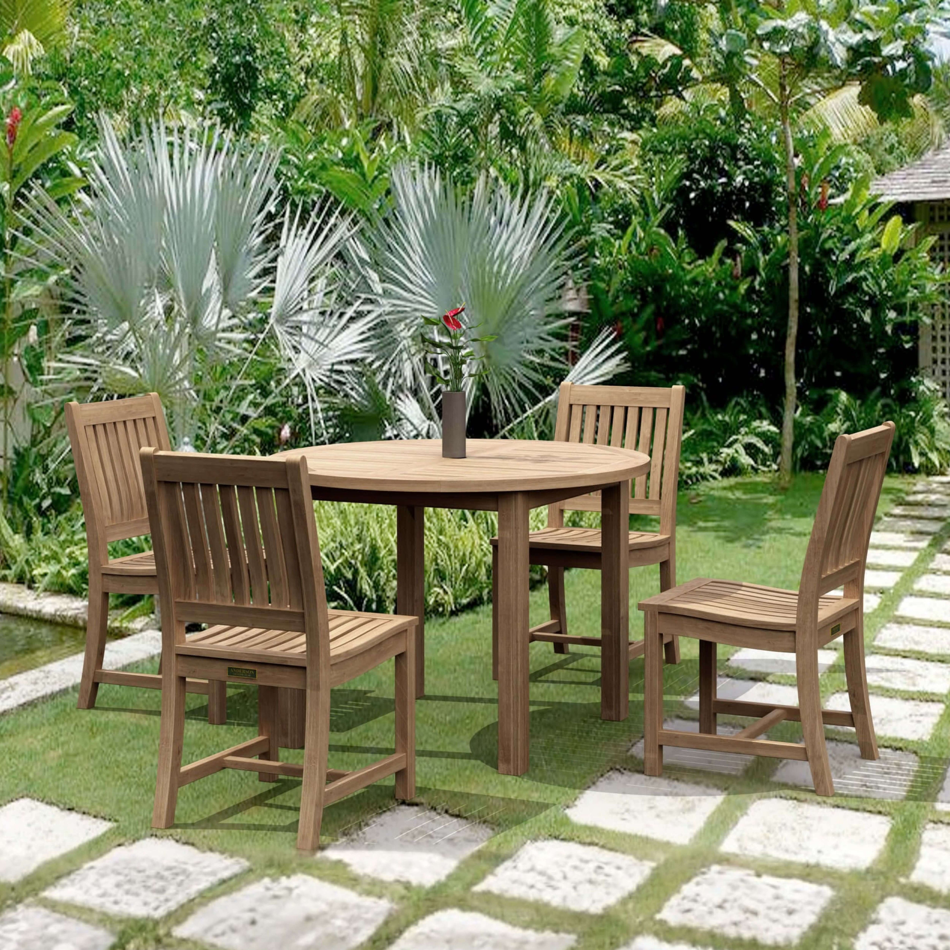 Sommerset five-piece round teak dining set with four Rialto chairs in a tropical garden