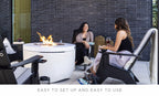 Ledge Lounger Halo Firepit lifestyle, guests relaxing with wine poolside