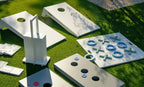 Two White Cornhole Toss boards in a backyard game setting; other games and furnishings shown are sold separately