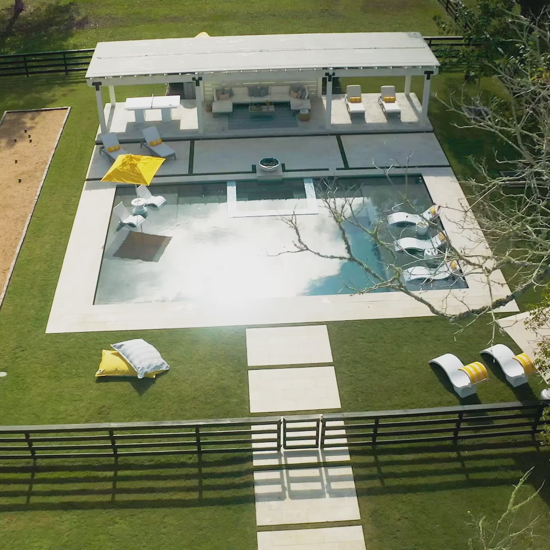 Video with an aerial view of a pool area furnished with White Signature Chaise Deep loungers