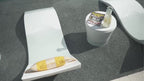 Video of a White Signature Chaise with a pillow and side table on a shallow pool ledge