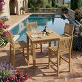 Chatsworth Avalon teak bar set beside a pool with flowering garden landscaping