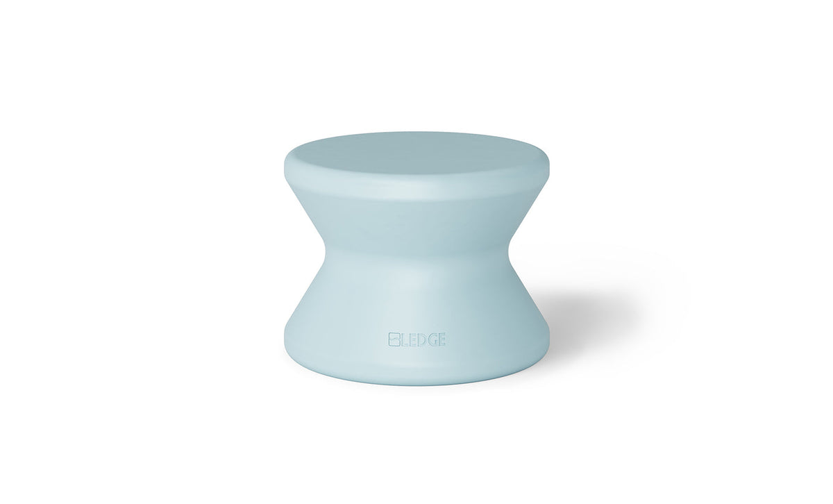Pale blue solid-top in-pool side table with a curved pedestal and no umbrella hole.