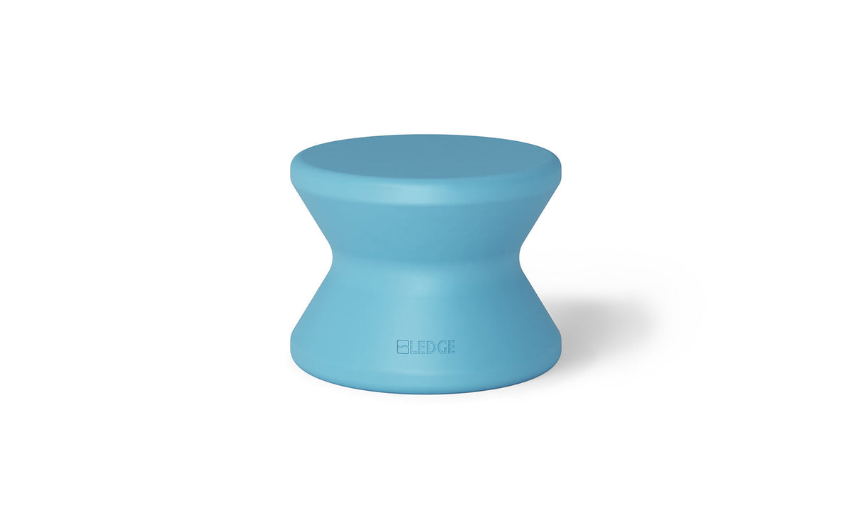 Light blue solid-top in-pool side table with a curved pedestal and no umbrella hole.