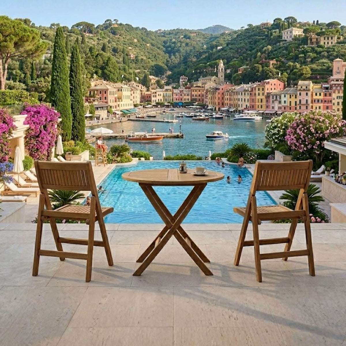 Windsor round teak bistro table and two folding chairs overlooking a pool and harbor