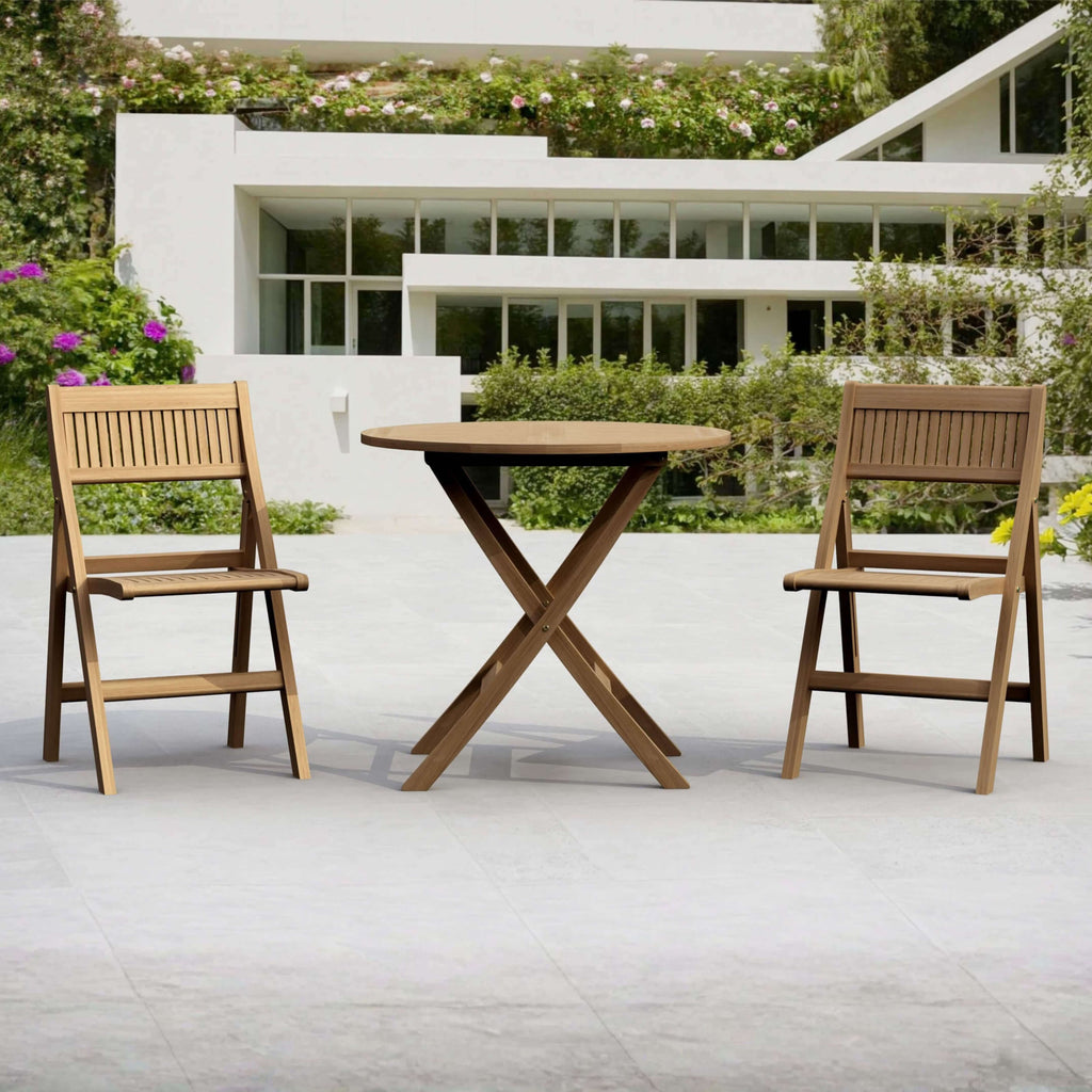 Windsor round folding teak table and two chairs on a modern garden terrace